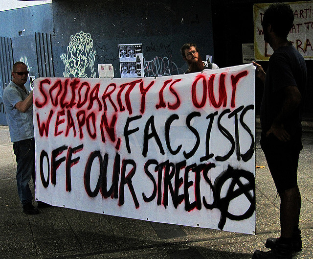 Rather than making excuses for what's going on, we need to unite and show solidarity with those being/at risk of being persecuted. (Photographer: Newtown graffiti; Flickr)